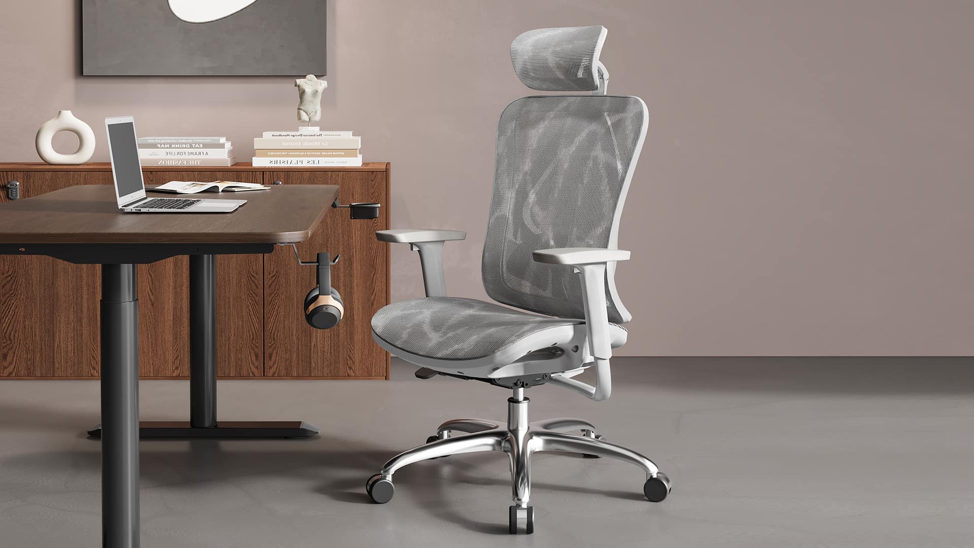 Gray mesh office chair beside a wooden desk and laptop